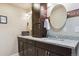 Modern bathroom with dual sinks, granite countertops, and dark wood cabinetry at 5755 S Fulton Way, Greenwood Village, CO 80111