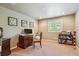 Cozy bedroom with neutral walls, plush carpeting, and natural light from window at 5755 S Fulton Way, Greenwood Village, CO 80111