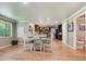Bright dining area with hardwood floors and a view into the kitchen at 5755 S Fulton Way, Greenwood Village, CO 80111