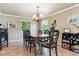 Elegant dining room with hardwood floors, chandelier, and view of the lush outdoors at 5755 S Fulton Way, Greenwood Village, CO 80111