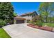 Well-maintained home with lush lawn, long driveway, and three car garage at 5755 S Fulton Way, Greenwood Village, CO 80111