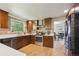Modern kitchen featuring stainless steel appliances, custom cabinets, and an open layout at 5755 S Fulton Way, Greenwood Village, CO 80111
