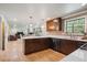 Modern kitchen with island, stainless steel appliances, and hardwood floors at 5755 S Fulton Way, Greenwood Village, CO 80111