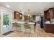 Eat-in kitchen featuring stainless steel appliances, breakfast bar, and custom cabinets at 5755 S Fulton Way, Greenwood Village, CO 80111
