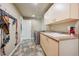 Functional laundry room with sink, washer, dryer, and ample storage at 5755 S Fulton Way, Greenwood Village, CO 80111