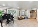 Bright living room features hardwood floors, piano, large windows, and elegant decor at 5755 S Fulton Way, Greenwood Village, CO 80111