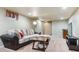 Spacious basement living room with plush seating, carpeting, and media center, perfect for relaxing and entertaining at 5755 S Fulton Way, Greenwood Village, CO 80111