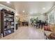 Open living room featuring hardwood floors, large windows, piano, and custom shelving at 5755 S Fulton Way, Greenwood Village, CO 80111