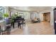 Bright living room featuring hardwood floors, large windows, and a grand piano at 5755 S Fulton Way, Greenwood Village, CO 80111