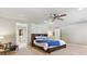 Serene primary bedroom with a ceiling fan, large bed, and an attached walk-in closet at 5755 S Fulton Way, Greenwood Village, CO 80111