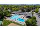 Aerial view of community pool area with blue swimming pools, lounge chairs, and shade umbrellas for residents' relaxation at 5755 S Fulton Way, Greenwood Village, CO 80111