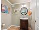 Cozy powder room with stylish vanity and decorative art at 5755 S Fulton Way, Greenwood Village, CO 80111