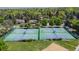 Aerial view of four community tennis courts surrounded by lush greenery, providing a recreational space for residents at 5755 S Fulton Way, Greenwood Village, CO 80111