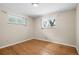 Bedroom featuring hardwood floors, neutral walls, and dual windows at 1662 S Everett St, Lakewood, CO 80232