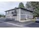 Two-story home has balcony, gray siding, two garages, and well-kept landscaping at 13393 E Louisiana Ave, Aurora, CO 80012