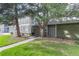 A charming exterior view of the home featuring a well-maintained lawn and mature trees at 13393 E Louisiana Ave, Aurora, CO 80012