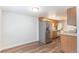 A cozy eat in kitchen featuring an abundance of storage, stainless refrigerator, and adjacent laundry area at 13393 E Louisiana Ave, Aurora, CO 80012