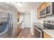 A functional galley kitchen with modern stainless steel appliances and generous cabinet space at 13393 E Louisiana Ave, Aurora, CO 80012