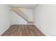 A spacious living room boasts wood-look flooring and an open staircase at 13393 E Louisiana Ave, Aurora, CO 80012
