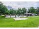 Community pool area with a basketball court, lounge area, and pool with green trees at 13393 E Louisiana Ave, Aurora, CO 80012