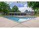 Community pool showing pool house, lounge area, and clear blue water with green trees at 13393 E Louisiana Ave, Aurora, CO 80012
