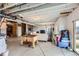 Unfinished basement area with potential for customization, featuring a foosball table and sitting area at 935 Peach Leaf Ln, Elizabeth, CO 80107