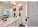 Bright bathroom boasting double sinks with marble countertops, decorative art and a mirror at 935 Peach Leaf Ln, Elizabeth, CO 80107