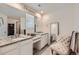 Bathroom featuring double sinks with granite countertop, vanity area and walk-in closet at 935 Peach Leaf Ln, Elizabeth, CO 80107