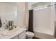 Bright bathroom with a white tiled shower/tub combination and a vanity with a white countertop at 935 Peach Leaf Ln, Elizabeth, CO 80107