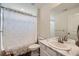 Bathroom with a shower tub, white curtain and single sink vanity with white countertop at 935 Peach Leaf Ln, Elizabeth, CO 80107