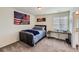 This bedroom features a comfortable bed, a desk and an American flag on the wall at 935 Peach Leaf Ln, Elizabeth, CO 80107