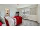Cozy bedroom featuring a comfy bed with bright red throw blanket, decor, and ample natural light at 935 Peach Leaf Ln, Elizabeth, CO 80107