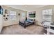 Bright bedroom with twin windows, neutral carpet, and a sports-themed design at 935 Peach Leaf Ln, Elizabeth, CO 80107