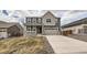 Inviting two-story home featuring a covered porch, neutral colors, and a well-maintained front yard at 935 Peach Leaf Ln, Elizabeth, CO 80107