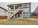Backyard elevation with patio, deck and staircase at 935 Peach Leaf Ln, Elizabeth, CO 80107