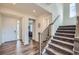 Welcoming foyer with hardwood floors, staircase, and plenty of natural light streaming through the front door at 935 Peach Leaf Ln, Elizabeth, CO 80107