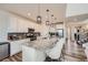 Modern kitchen boasts granite countertops, stainless steel appliances, and a large island with bar seating at 935 Peach Leaf Ln, Elizabeth, CO 80107