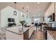 Open concept kitchen with stainless steel appliances, granite counters, and island with a sink and seating at 935 Peach Leaf Ln, Elizabeth, CO 80107