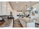 Stylish kitchen featuring stainless steel appliances, gray backsplash, granite counters, and bar stool seating at 935 Peach Leaf Ln, Elizabeth, CO 80107
