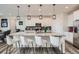 Beautiful kitchen island features granite counters, pendant lighting, stainless appliances and modern seating at 935 Peach Leaf Ln, Elizabeth, CO 80107