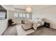 Serene main bedroom with neutral color palette, chaise lounge, and large windows offering great views at 935 Peach Leaf Ln, Elizabeth, CO 80107