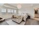 Light and airy main bedroom featuring a cozy chaise lounge, neutral decor, and ample natural light at 935 Peach Leaf Ln, Elizabeth, CO 80107