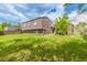 Spacious backyard with lush green grass and mature tree offers outdoor enjoyment at 11599 Kendall St, Westminster, CO 80020