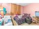 This bedroom is well lit by a window and has a bed, pillows, and dresser at 11599 Kendall St, Westminster, CO 80020