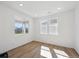 Bright bedroom featuring hardwood floors, white walls, and an abundance of natural light at 1331 Rock Cliff Ave, Erie, CO 80516