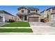 Inviting two-story home with a manicured lawn, a two-car garage, and a charming front porch at 1331 Rock Cliff Ave, Erie, CO 80516
