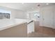 Upstairs hallway with carpeted floor, white walls and natural light from the large window at 1331 Rock Cliff Ave, Erie, CO 80516