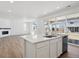 Bright kitchen with quartz counters, stainless appliances, and an open floor plan at 1331 Rock Cliff Ave, Erie, CO 80516