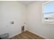 A functional laundry room with modern hookups and a window for natural light at 1331 Rock Cliff Ave, Erie, CO 80516