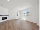Open living room with wood floors, recessed lighting, and a modern fireplace at 1331 Rock Cliff Ave, Erie, CO 80516